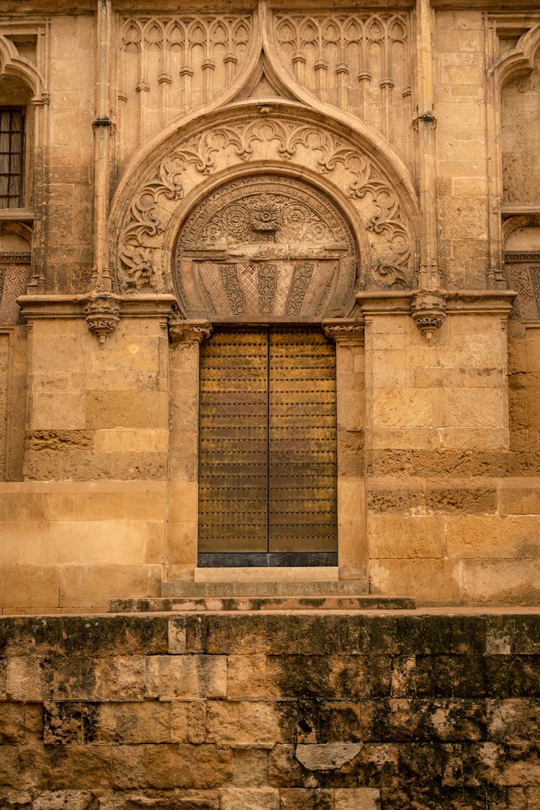 Intricate stonework entrance of a Roman Catholic cathedral in Córdoba, Spain.